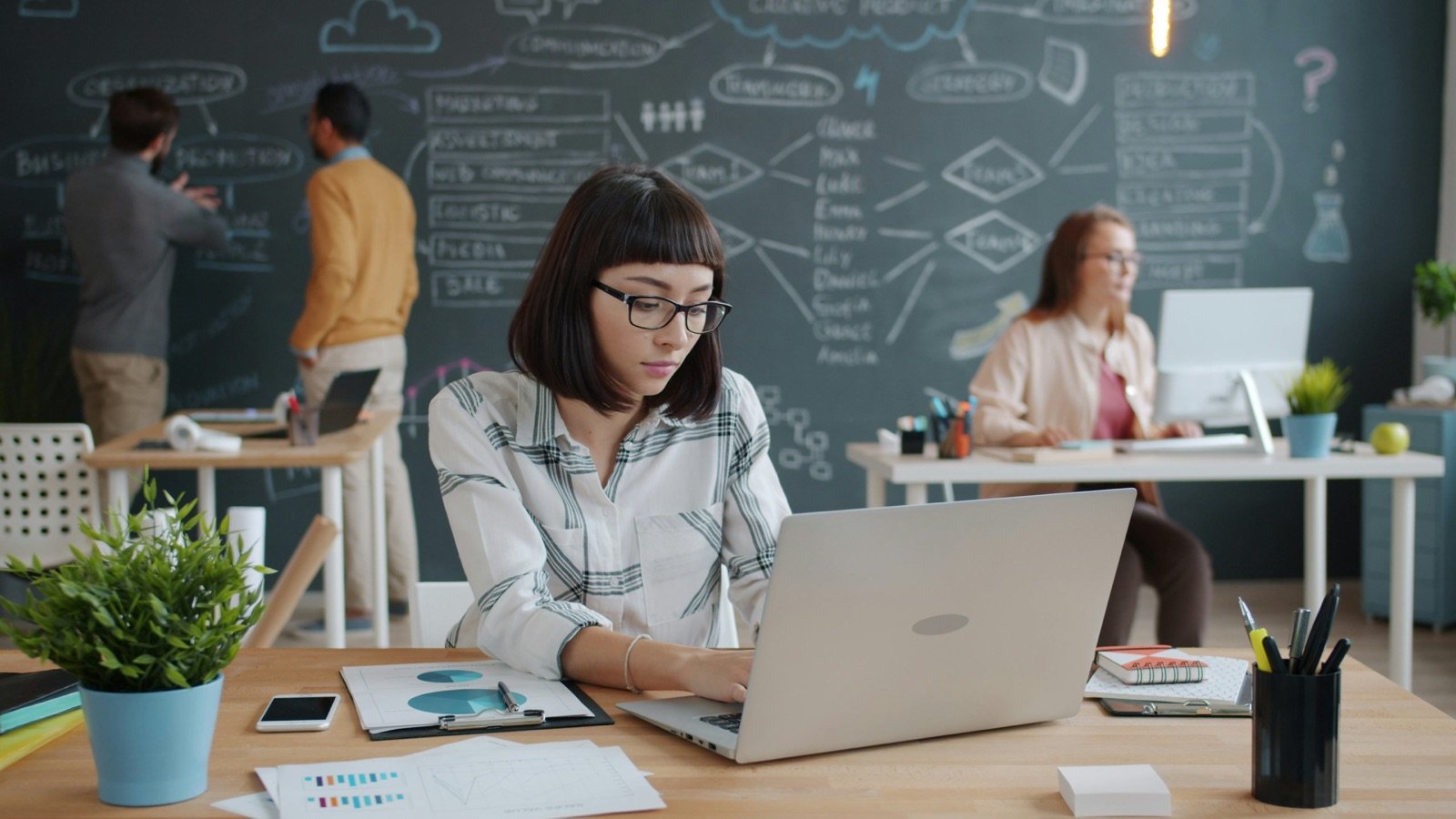 A professional technology team working in a modern office